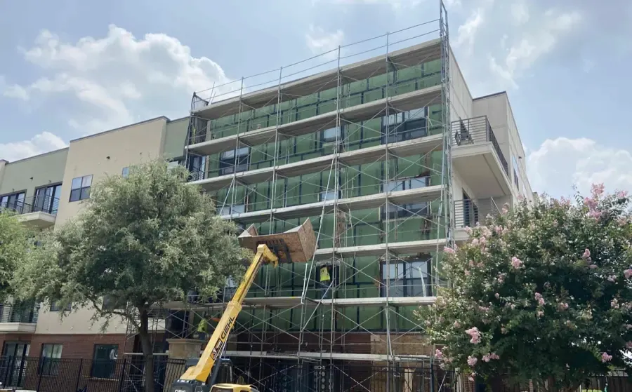 Exterior sheathing around window openings during facade recladding