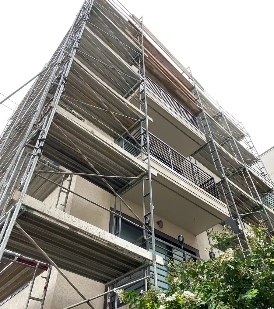 Scaffolding along a multi-family building during facade recladding