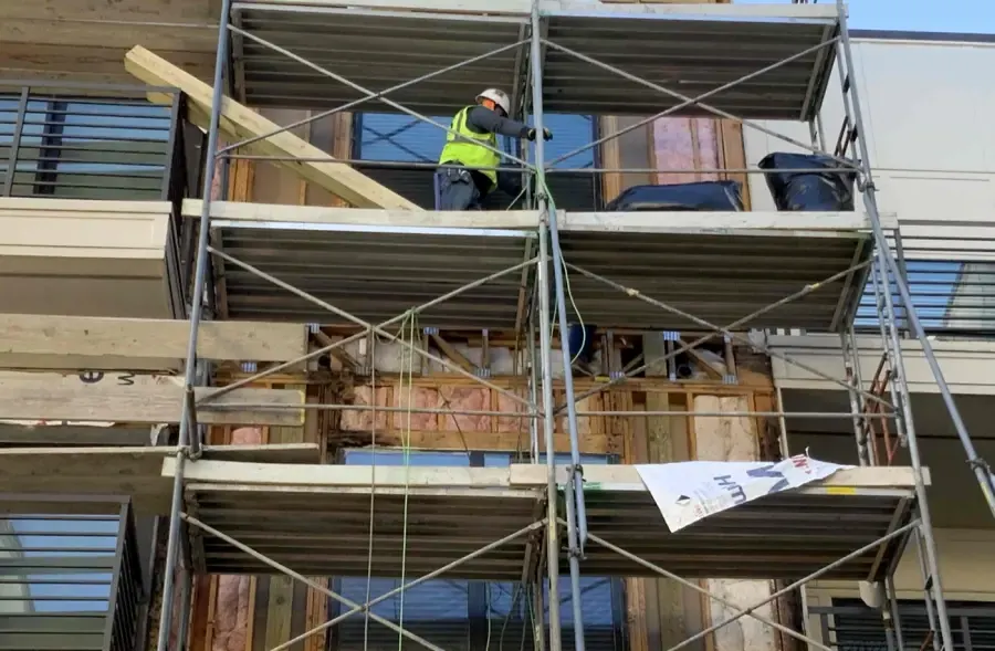 Exposed framing and insulation around windows during exterior repairs