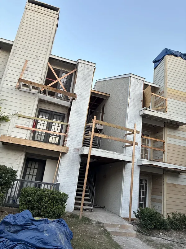 Multifamily building exterior during fire-loss reconstruction in Dallas